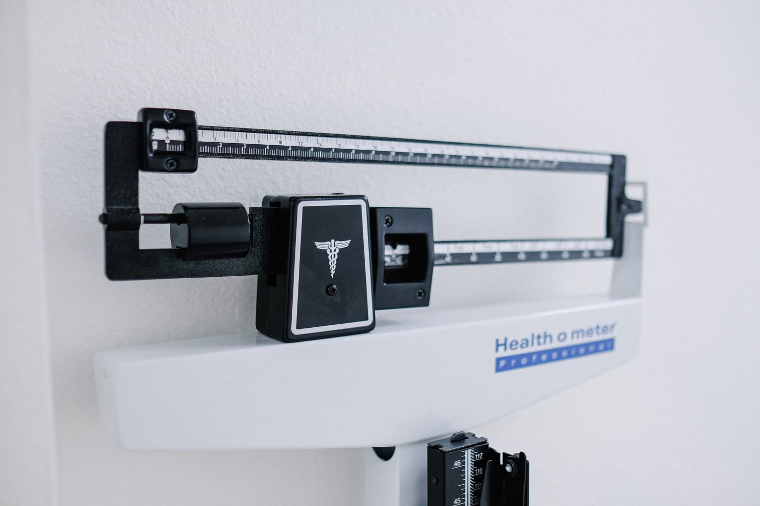 A doctor's office weight scale, often used to calculate body mass index (BMI)