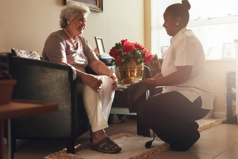 Female nurse visiting senior patient for checking blood pressure. Subscription Healthcare Models Superior