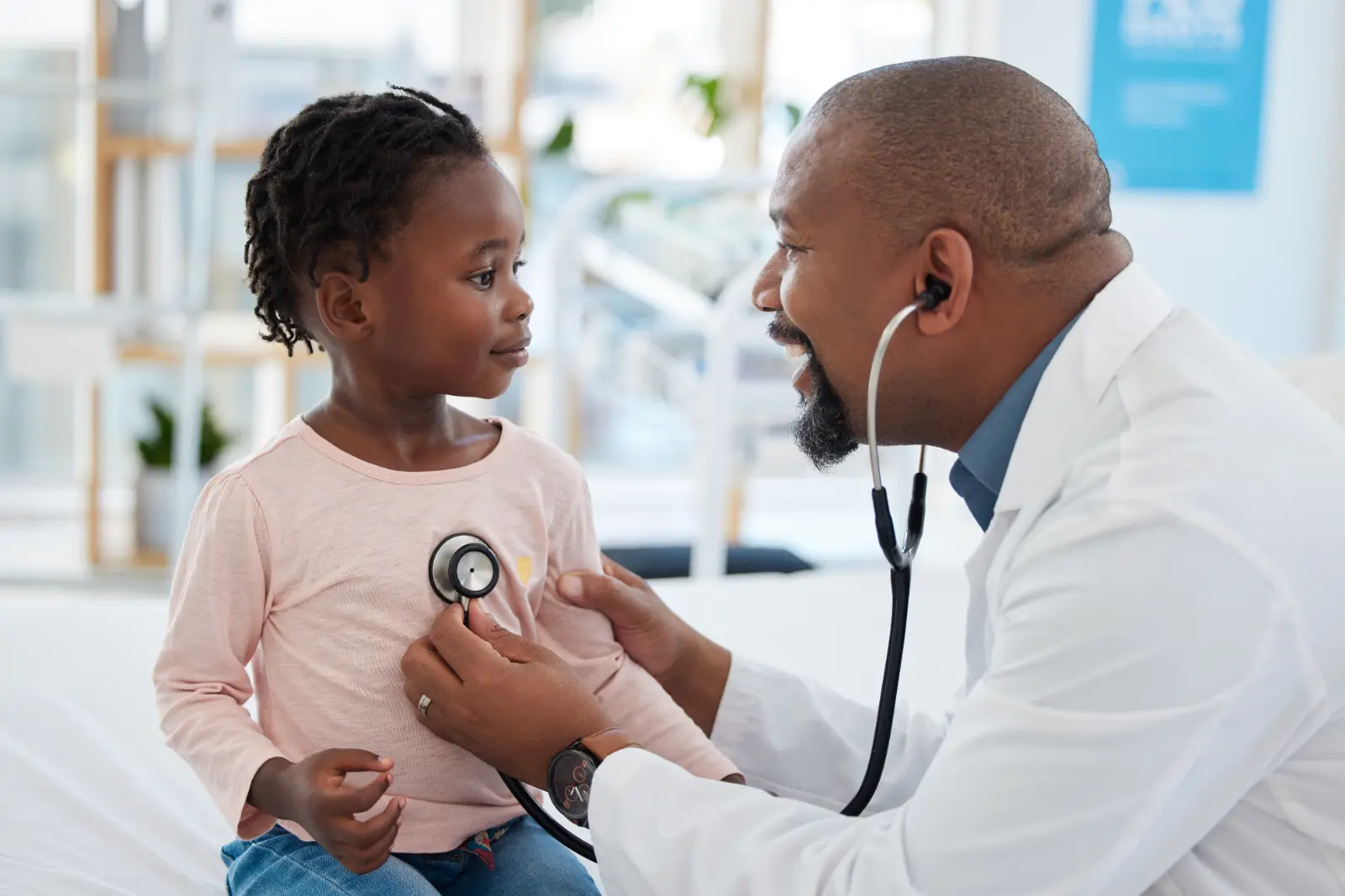 A doctor using a stethoscope to listen to a young girl's heart. He is an example of a Subscription-Based Primary Care provider.