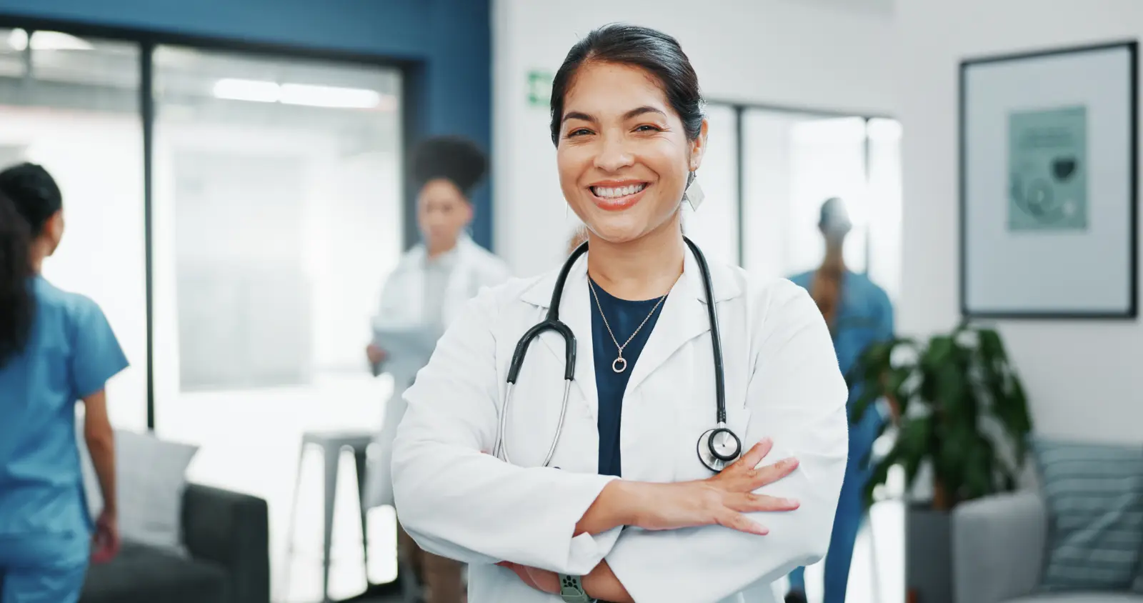 portrait nurse smiling in hall thinking about the good of subscription vs Traditional Patient Care Models